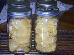 two mason jars filled with peeled bananas on a wire cooling rack next to a lace doily