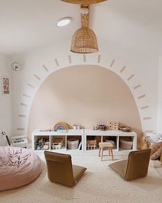 a living room filled with lots of furniture next to a white table and chair covered in pillows