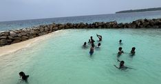 several people are swimming in the ocean together