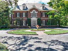 a large red brick house surrounded by trees