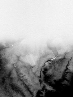 an airplane is flying through the clouds in black and white photo taken from above on a cloudy day