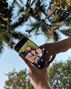 a person holding up a cell phone to take a selfie with the image on it