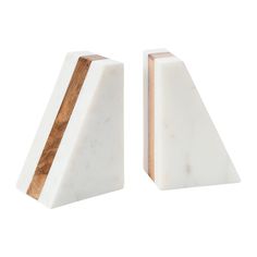 two white marble bookends with wood accents on each side, one in the shape of a triangle