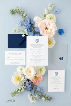 the wedding stationery was done in navy and white, with blue envelopes that were accented with flowers