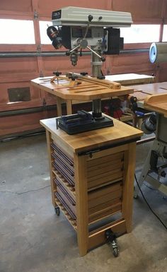 two workbenches in a garage with tools on the table and an electric driller