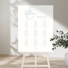 a table plan sitting on top of a easel next to a potted plant