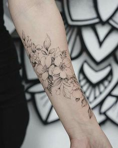 a woman's arm with flowers on it