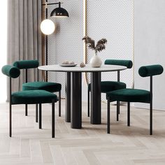 a dining table with four chairs and a vase on it in front of a white wall