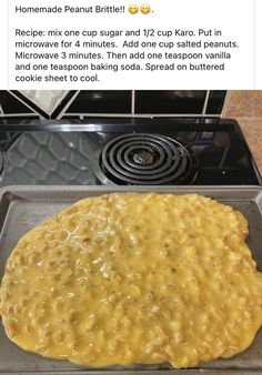 an uncooked pizza sitting on top of a metal pan next to a stove