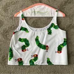 This Sleeveless Crop Top Is Nwot, New Without Tags. It Is A Handmade Sleeveless Crop Top Purchased From Etsy. The Front Has The Very Hungry Caterpillar Design And The Back Is Just White Fabric. This Is A Xs/Small. Please Feel Free To Reach Out With Any Questions On Measurements. This Material Is A Little Sheer, So Please Keep That In Mind. And As It Is Homemade Keep That In Mind As Well. Please Feel Free To Reach Out With Any Questions Or Offers :) The Very Hungry Caterpillar, Very Hungry Caterpillar, Very Hungry, Hungry Caterpillar, Sleeveless Crop Top, White Fabric, White Fabrics, Caterpillar, Crop Top