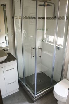 a bathroom with a toilet, sink and shower stall