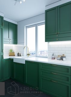 a kitchen with green cabinets and white counter tops