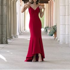 a woman in a red dress posing for the camera