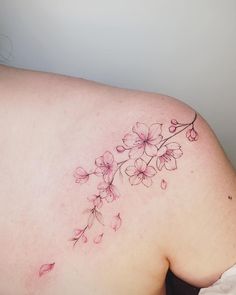 a woman's back with pink flowers on it