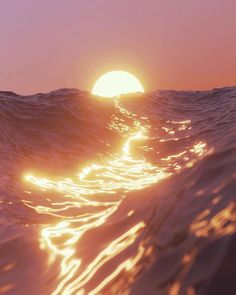 the sun is setting over an ocean wave as seen from the water's surface