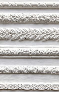 white painted wood with decorative designs on it