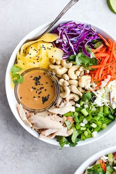 two white bowls filled with different types of salads and dressing next to each other