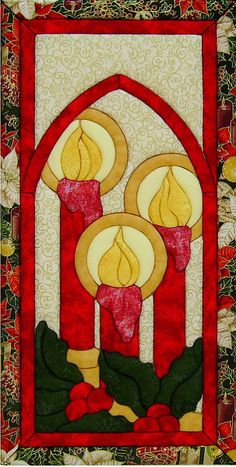 a quilted wall hanging with candles and holly wreaths in front of a stained glass window