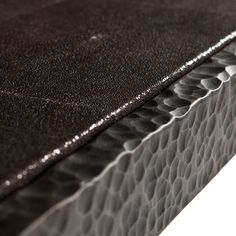 a close up view of a black leather mattress