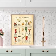 a poster with different types of cocktails in glasses on the wall above a kitchen sink