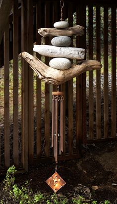 a wind chime made out of rocks and wood