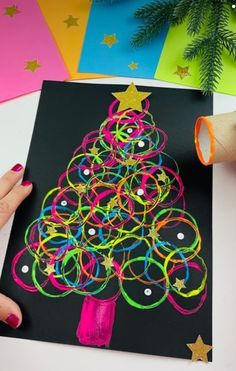 someone is making a christmas tree out of colored paper