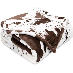 the blanket is brown and white with black spots