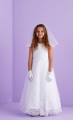 Stunning Ankle length first Holy Communion sleeveless dress. The duchess satin dress with guipure motif detail on the bodice is complemented by the impressive scallop hem embroidery detail of the net tulle overlay skirt.  Fastened at the back with pearl buttons. This classic dress promotes pure elegance whilst maintaining comfort during the Communion blessing. Our dresses are all made to the highest quality and are available in sizes 7,8,9 & 10 years. We also have a wide range of beautiful boler Sleeveless Floral Applique Dress For First Communion, Sleeveless Dresses With Floral Applique For First Communion, Sleeveless Tulle Gown For Confirmation, Sleeveless Lace Dress For Confirmation, Sleeveless Lace Dress For First Communion, Sleeveless Dress With Lace Bodice For First Communion, Elegant Sleeveless Gown For Confirmation, Fitted Sleeveless Gown For First Communion, Sleeveless Lace Bodice Dress For Confirmation