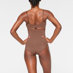 Shape your curves and feel supported in this stretchy shapewear high waisted brief with strong targeted compression at the tummy and waist, butt-shaping pockets, and a silicone interior underband that keeps it from rolling down. Hits right below the bust and features a wider crotch for added coverage and a cotton gusset. Fits true to size. | SKIMS High-Waisted Brief | Medium Neutral | Seamless Sculpt High Waisted Briefs, Shapewear, Lounge Wear, High Waisted