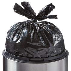 a black trash bag sitting on top of a metal trash can