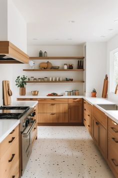 the kitchen is clean and ready for us to use it's counters, shelves, and drawers