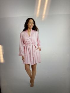 a woman in a pink robe posing for a photo