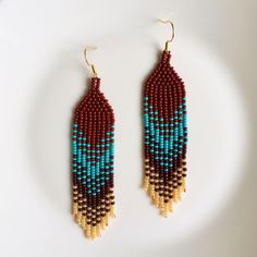 Add brightness to your everyday outfit using these fringe beaded earrings. Inspired by tribal style, these statement seed bead earrings are made with a bright gradient pattern in chocolate brown, turquoise blue, dark brown, and beige colors. No doubt, these elegant colorful earrings would catch all eyes. These artisan earrings are making the perfect choice for those who are looking for trendy bohemian or hippie earrings. Length: 3.94'' / 10 cm Width: 0.79'' / 2 cm Material: Czech seed beads, stainless steel accessories. 100% top quality handmade earrings The real color of the item may be slightly different from the picture shown on website caused by the brightness of your monitor. If you have special size requirements, please send me a letter about it, as this can be made to order. More be Bohemian Brown Beaded Earrings, Adjustable Brown Earrings With Beaded Fringe, Brown Fringe Dangle Beaded Earrings, Traditional Brown Beaded Fringe Earrings, Bohemian Brown Fringe Earrings, Bright Gradient, Fringe Beaded Earrings, Gradient Pattern, Elegant Bohemian