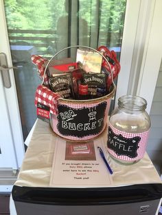 a basket filled with chocolates sitting on top of a table next to a glass jar