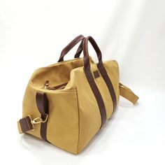 "This Travel Bag is made from 18 oz harvest tan canvas with brown leather trims. SIZE: 20\" wide x 13\" Tall x 11\" depth Features: 2\" adjustable cross bodyt strap (Removable) 2 sides handles Inside zipper pocket 9\"x10\" Metal tooth zipper for long lasting use Stitched with nylon tread for durability. ♡ PROCESSING TIME: Your travel bag will ship within 1-3 business day after purchase. ♡ SHIPPING TIME: 2-5 business days within the US via UPS. ♡ GIFTS: You can ship our products directly to your Brown Large Capacity Canvas Satchel Bag, Canvas Travel Bag For Everyday Use, Everyday Duck Canvas Bag With Leather Trim, Large Capacity Khaki Canvas Travel Bag, Duck Canvas Satchel Bag For Daily Use, Brown Canvas Bags With Canvas Lining, Duck Canvas Satchel For Daily Use, Outdoor Canvas Travel Bag With Leather Trim, Brown Canvas Bags With Leather Handles