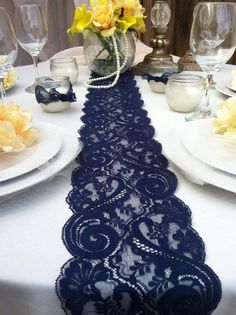 the table runner is blue with white lace on it and has an image of a woman in