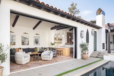 an outdoor living area with couches and tables