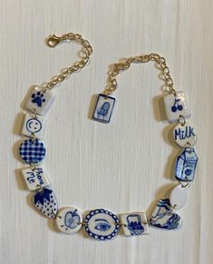 a blue and white bracelet with charms on it