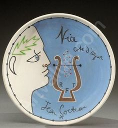 a blue and white plate with an image of a man's face