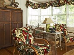 a living room filled with furniture next to a window covered in curtains and valances