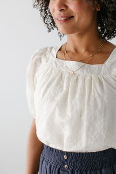 Introducing the beautiful 'Sybil' top, a delightful blend of elegance and grace! This top features dainty details that are sure to enhance any outfit. Pair with a smocked midi skirt and sandals for a feminine look or dress it up with a floral skirt and heels! Exclusively designed with you in mind. 100% Tencel Hand Wash Cold Do Not Bleach Hang or Lay Flat to Dry (Inside Out Only) Low Iron if Needed Do Not Iron Embroidery Fully Lined Model Height 5'9" | Wearing Size Small Model Height 5'8" | Wearing Size 1X Please carefully measure a similar item before placing your order to allow for the best fit and also to reduce the risk of returns. Have questions about fit? Call us! We try everything on, so we know how our clothes fit and we’re happy to assist you. Customer Service: 717.598.8309 9 AM - Feminine Smocked Bodice Blouse With Square Neck, Feminine Blouse With Smocked Bodice And Square Neck, Feminine Smocked Top For Brunch, Elegant Spring Top With Smocked Bodice, Elegant Spring Tops With Smocked Bodice, Elegant Tops With Smocked Bodice For Spring, Elegant Top With Smocked Back And Square Neck, Elegant Tops With Smocked Back And Square Neck, Elegant Tops With Smocked Back For Brunch