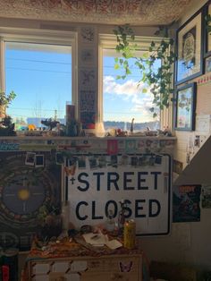 there is a sign that says street closed in front of a window with pictures on it