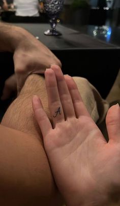 a person with a small tattoo on their left hand