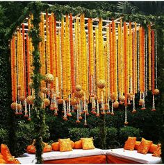 an orange and white wedding with lots of flowers on the wall behind the couches