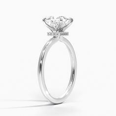 a white gold engagement ring with an oval center stone