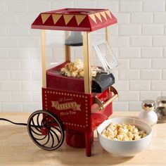 a popcorn machine sitting on top of a wooden table