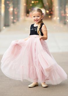 Dress your little one in the enchanting Mauve & Black Tulle Flower Girl Dress to make her feel like a princess at weddings and special occasions! This stunning dress features a delicate black lace bodice combined with a whimsical long flowing mauve ruffle tulle skirt, creating a perfect harmony between elegance and charm. Perfect for dreamy, romantic, fairytale, or classic wedding themes, this dress will surely make your little girl stand out. For an extra touch of magic, pair it with matching b Elegant Flowy Tulle Skirt Dress, Elegant Flowy Dress With Tulle Skirt, Fitted Gown With Lace Bodice For Dress-up, Elegant Pink Tutu Dress For Garden Party, Elegant Tulle Princess Dress For Garden Party, Pink Bridesmaid Dress With Flowy Skirt, Black Princess Dress For Summer, Fitted Princess Style Bridesmaid Dress, Elegant Pink Princess Dress For Garden Party