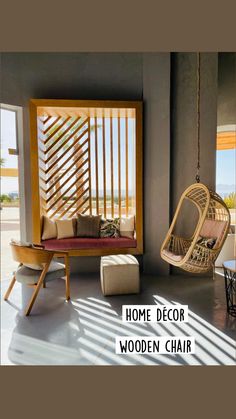 a living room filled with furniture and a hanging chair next to an open window overlooking the ocean