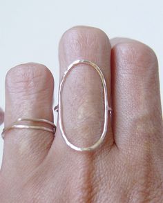 This stunning ring features a oval open circle band of 14K gold fill that wraps around your finger reminiscent of planet Saturn. Stylish and elegant. Perfect for everyday wear. Please specify your ring size and material at the checkout convo section. These rings are made to order. My QUALITY: Gold filled pieces contain 100+ times more real gold than gold plated pieces. They are durable and tarnish resistant. Gold filled pieces are a high quality, affordable alternative to solid gold for people w Sterling Silver Oval Stackable Rings, Simple Oval Sterling Silver Rings, Modern Oval Stackable Rings With Polished Finish, Hand Forged Oval Ring, Everyday Simple Oval Rings, Handmade Oval Stackable Rings For Everyday, Modern Oval Jewelry With Simple Design, Modern Oval Rings With Simple Design, Modern Handmade Oval Rings