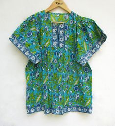 "ITEM DESCRIPTION ethnic casual wear women look blouse and tops - split neckline blouse - short kimono sleeve blouse Features: short sleeve, split neck, blouse Material: Cotton cambric Fabric: 100% cotton soft light weight ethnic print fabrics  Sleeve Length = 9 inch For more sizes & their measurement, please refer our below chart to understand the sizes variations available with us For your size requirement, please mention your size in seller note at the time of buying. SIZE MEASUREMENT  BUSTLENGTHSHOULDER XXS34 inch28 inch13.5 inch XS36 inch28 inch14 inch S38 inch28 inch14.5 inch M40 inch28 inch15 inch L42 inch28 inch16 inch XL44 inch28 inch16.5 inch 2XL46 inch28 inch17 inch 3XL48 inch28 inch18 inch   Company Return Policy:  Please write for more information to my email directly CHOOSE \ Half Kimono, Flower Print Blouse, Blue Floral Top, Bohemian Blouses, Casual Wear Women, Short Kimono, Women Blouse, Ethnic Print, Blouse Tops